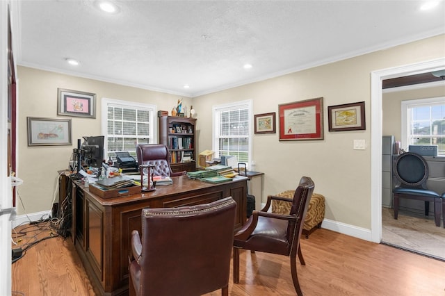 home office with crown molding, light hardwood / wood-style floors, and a textured ceiling