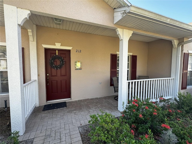 property entrance featuring covered porch