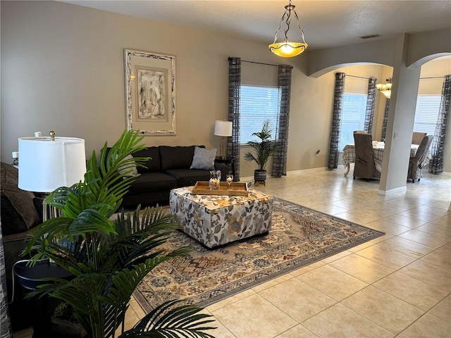 living room with light tile patterned floors and a healthy amount of sunlight