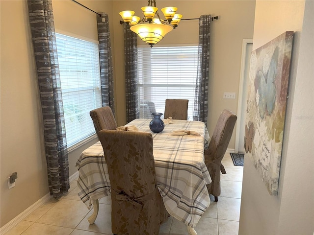 dining space with light tile patterned floors and a notable chandelier