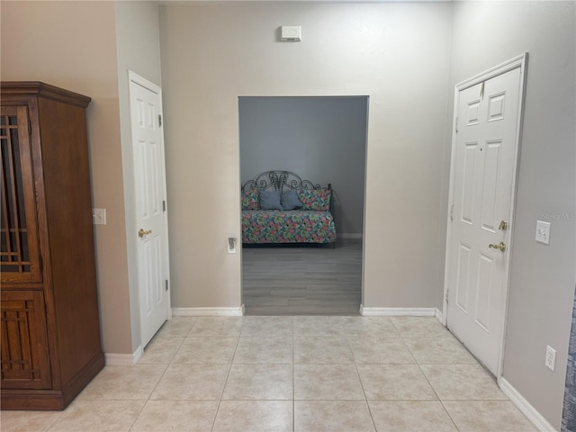 hall featuring light tile patterned flooring