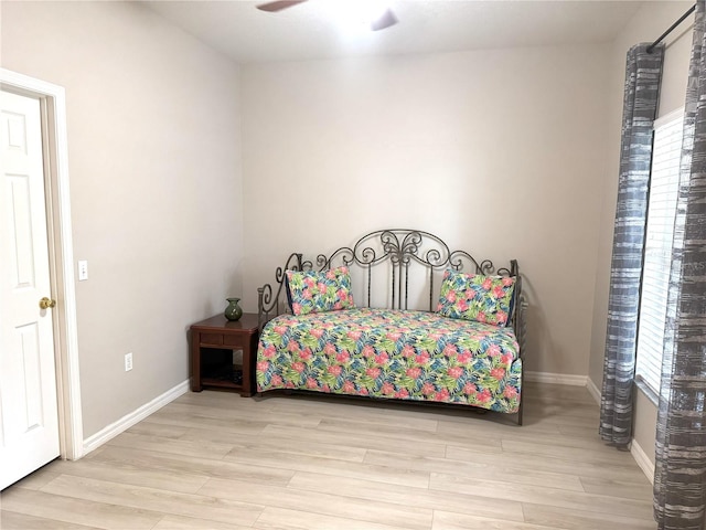 bedroom with light hardwood / wood-style floors and ceiling fan