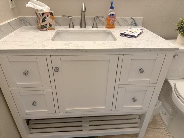 bathroom with tile patterned floors, vanity, and toilet