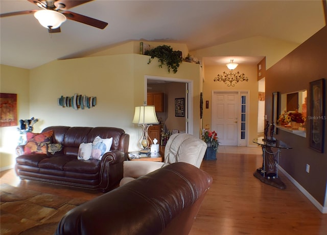 living room with hardwood / wood-style floors, ceiling fan, and vaulted ceiling