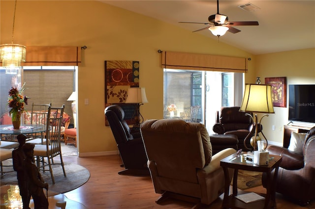 living room with hardwood / wood-style flooring, vaulted ceiling, and ceiling fan