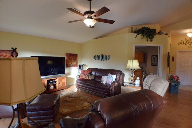 living room with wood-type flooring, vaulted ceiling, and ceiling fan