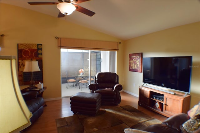 living room with hardwood / wood-style flooring, vaulted ceiling, and ceiling fan