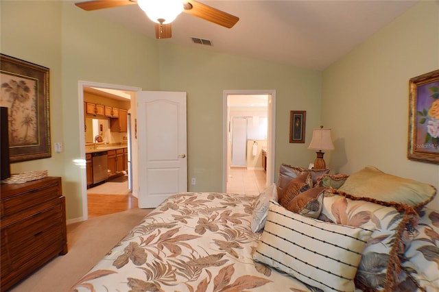 bedroom featuring ensuite bath, ceiling fan, sink, light colored carpet, and lofted ceiling