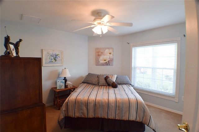 bedroom with ceiling fan and light carpet