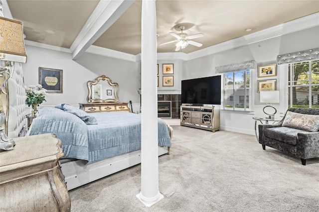 bedroom featuring crown molding, ceiling fan, a fireplace, beam ceiling, and carpet floors