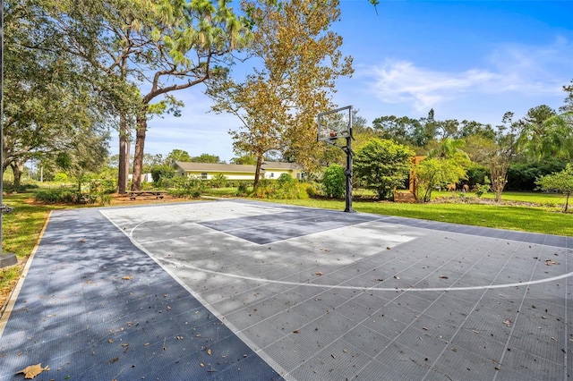 view of sport court featuring a lawn