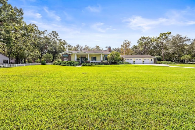 ranch-style home with a front lawn and a garage