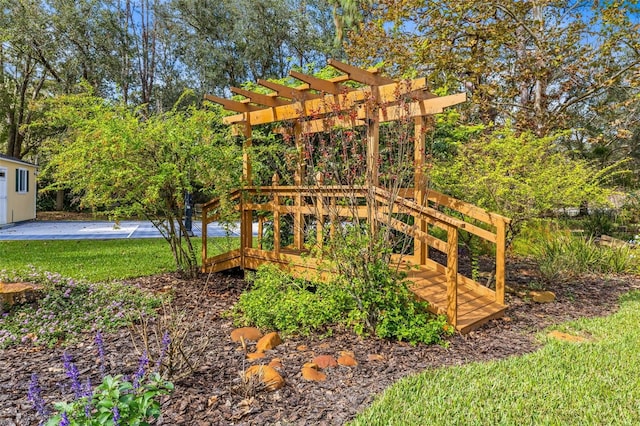 view of play area featuring a deck and a pergola