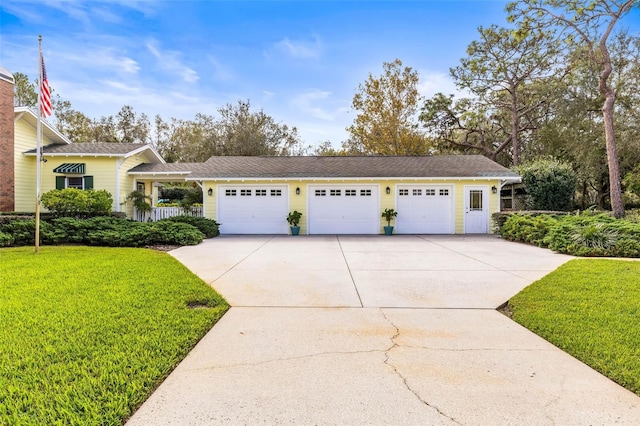 view of front of property featuring a garage and a front lawn