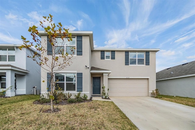 view of front of home with a garage and a front lawn