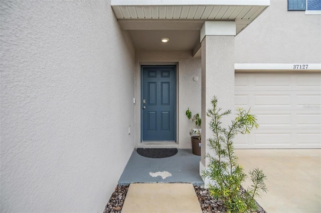 view of exterior entry with a garage