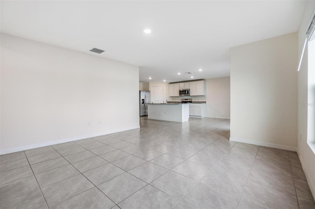 unfurnished living room with light tile patterned floors