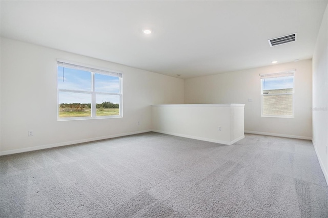 unfurnished room featuring light carpet