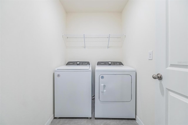 clothes washing area with separate washer and dryer