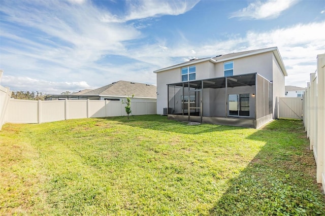 rear view of house featuring a lawn, a lanai, and central AC