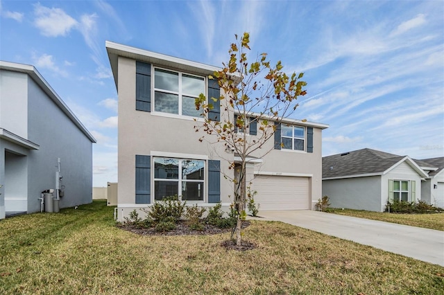 view of front of house with a front yard and a garage