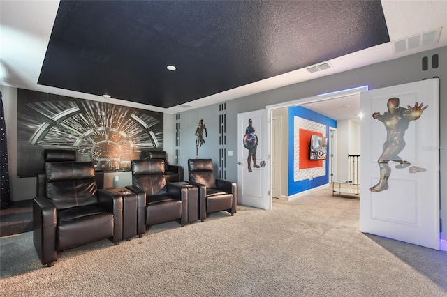 cinema room featuring a textured ceiling and carpet floors