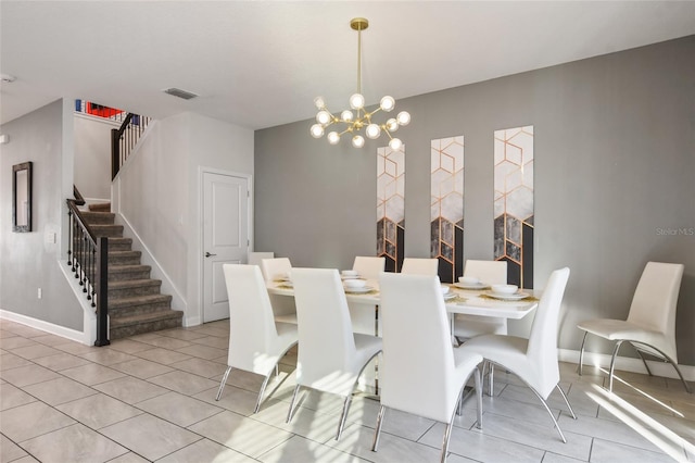 dining space with a notable chandelier and light tile patterned floors