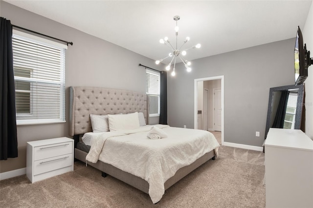 bedroom with a chandelier and light colored carpet