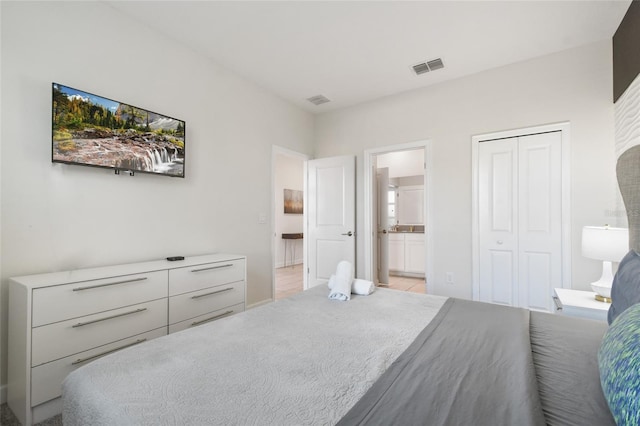 bedroom featuring a closet and ensuite bath