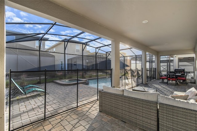 view of patio featuring glass enclosure, a pool with hot tub, and an outdoor hangout area