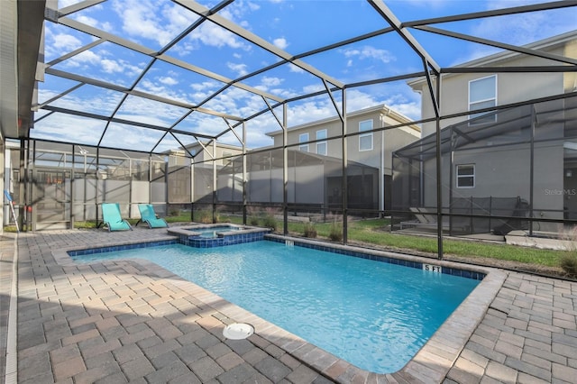 view of pool featuring an in ground hot tub, a patio area, and a lanai