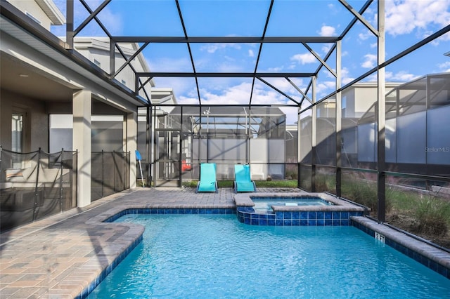 view of swimming pool featuring a lanai, an in ground hot tub, and a patio