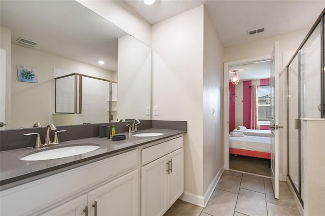 bathroom with tile patterned flooring, vanity, and an enclosed shower