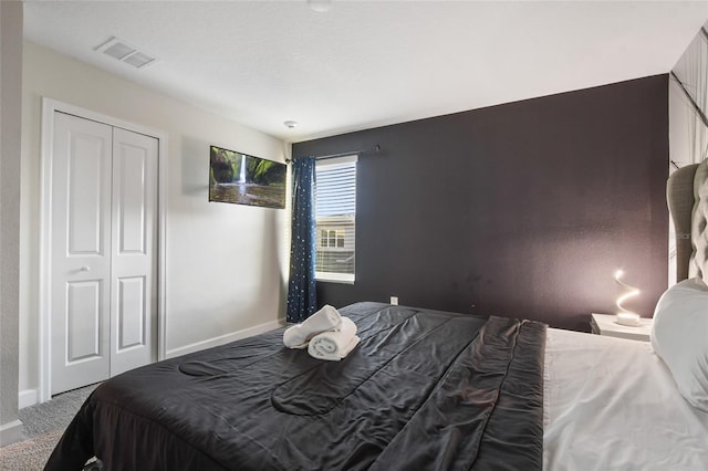 carpeted bedroom featuring a closet