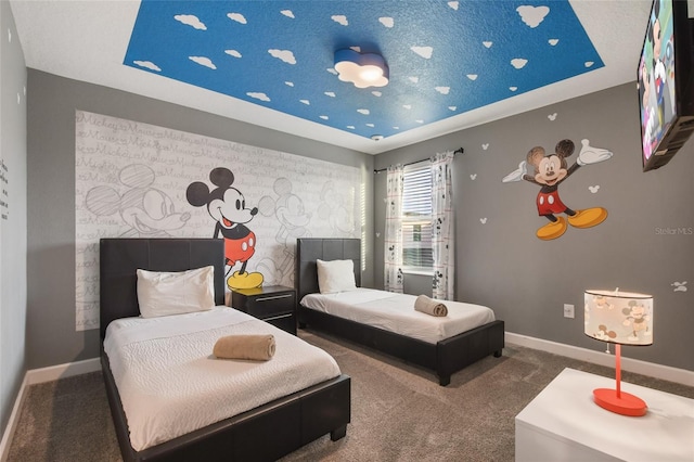 bedroom with a raised ceiling and carpet floors