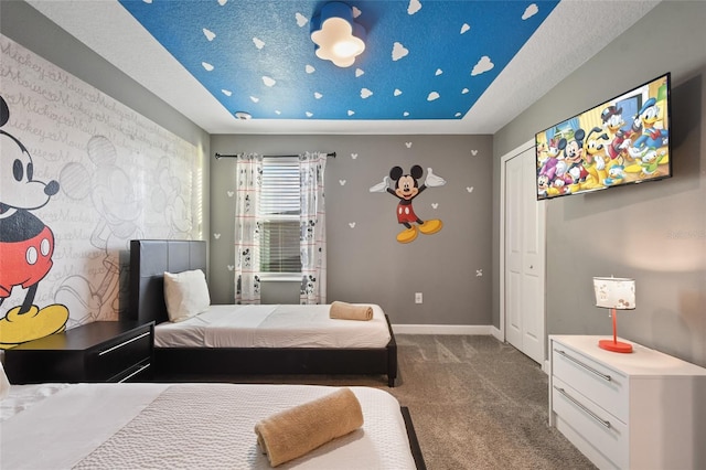 carpeted bedroom with a textured ceiling