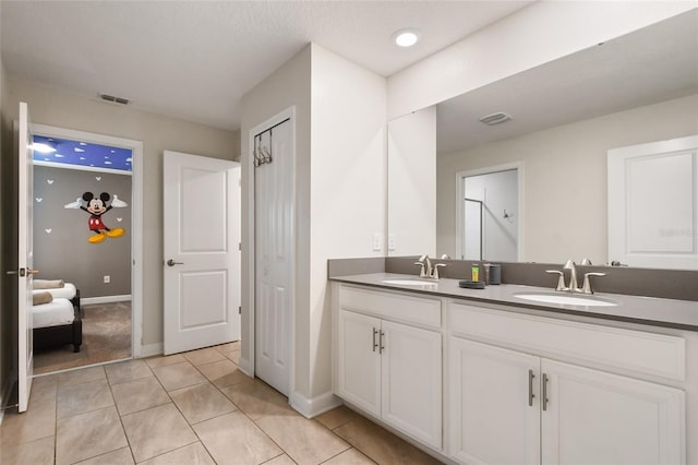 bathroom with tile patterned flooring and vanity