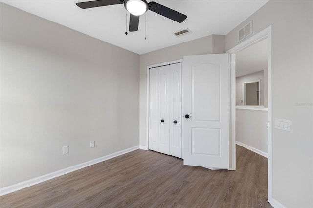 unfurnished bedroom with hardwood / wood-style flooring, ceiling fan, and a closet