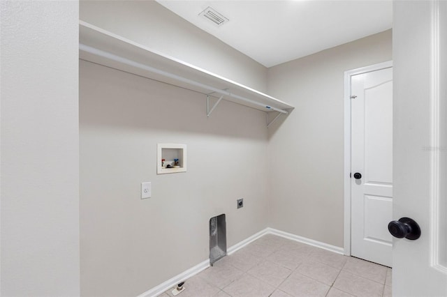 washroom featuring electric dryer hookup, light tile patterned flooring, and washer hookup