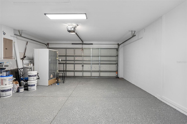 garage featuring electric panel and a garage door opener