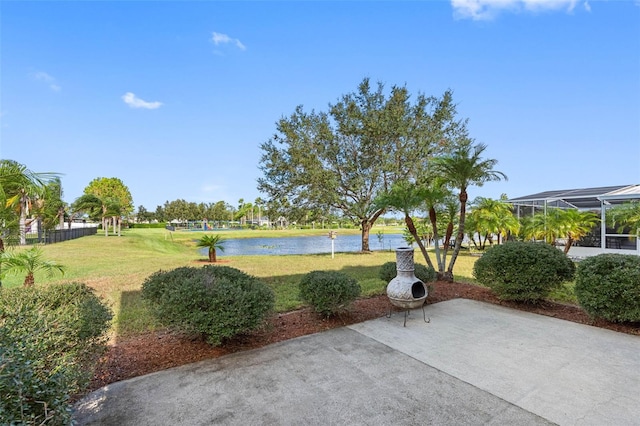 exterior space featuring a lanai and a water view