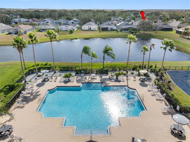 view of swimming pool featuring a patio area and a water view