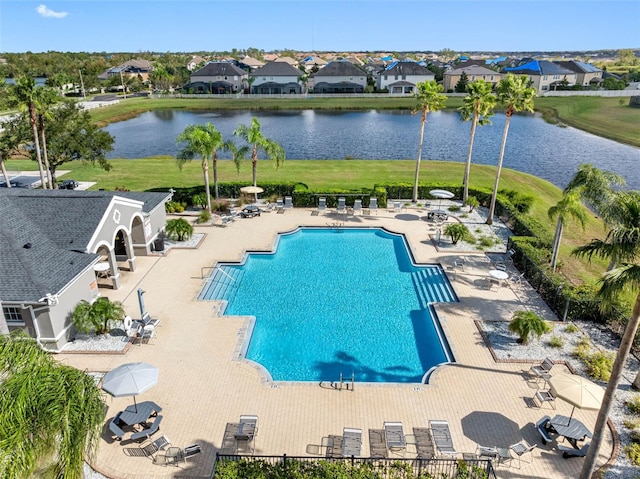 view of swimming pool with a water view and a patio