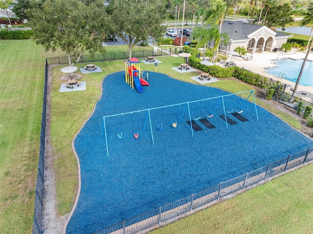 view of property's community featuring a playground and a lawn