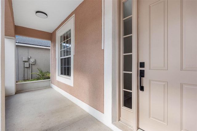 entrance to property featuring stucco siding