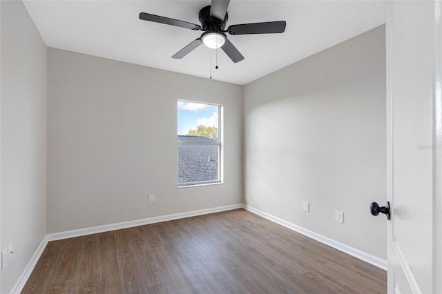 unfurnished room with a ceiling fan, baseboards, and wood finished floors