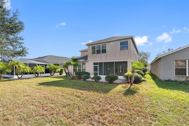 rear view of property with a lawn and stucco siding