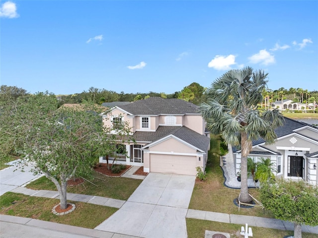 view of front of property featuring stucco siding, a front yard, a garage, a residential view, and driveway