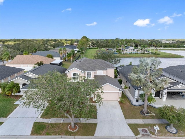 birds eye view of property with a water view and a residential view