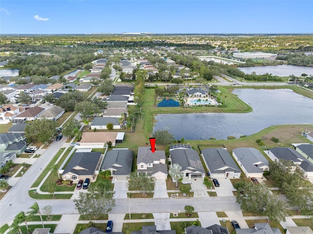 drone / aerial view featuring a water view and a residential view